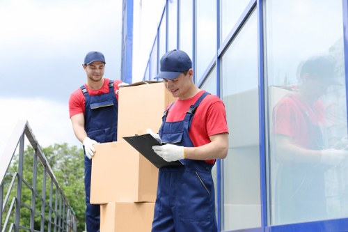 Man And A Van Kingston team loading items safely with protective measures in place
