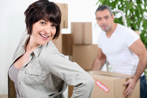 Professional movers handling boxes and furniture for a same day move